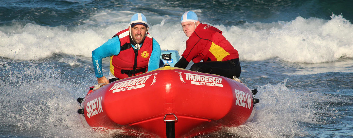 Surf Lifesavers in a rib surfing a wave wearing Sharkskin Rapid Dry